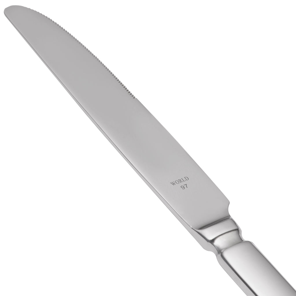 World Tableware 213 5511 Baguette 8 3/4" 18/0 Stainless Steel Heavy Weight Serrated Solid Handle Dessert Knife with Pinched Bolster - 12/Pack